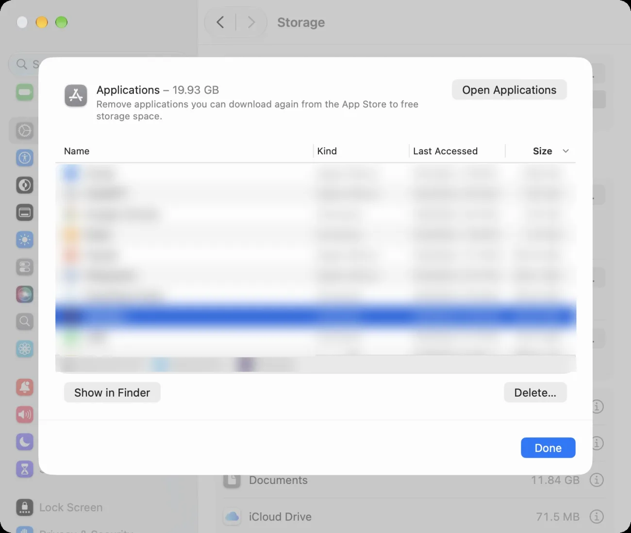 The window that opens from the i button next to Applications in Storage. At the top, Applications – 19.93 GB and the note Remove applications you can download again from the App Store to free storage space. Below it, a list with the columns Name, Kind, Last Accessed, and Size, sorted by Size. The rows are blurred. At the bottom are the buttons Show in Finder and Delete…