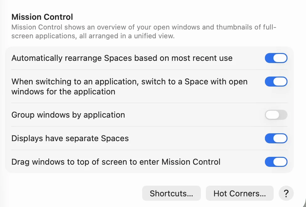 The bottom of Desktop & Dock in System Settings. The Mission Control section includes Displays have separate Spaces, which is turned on