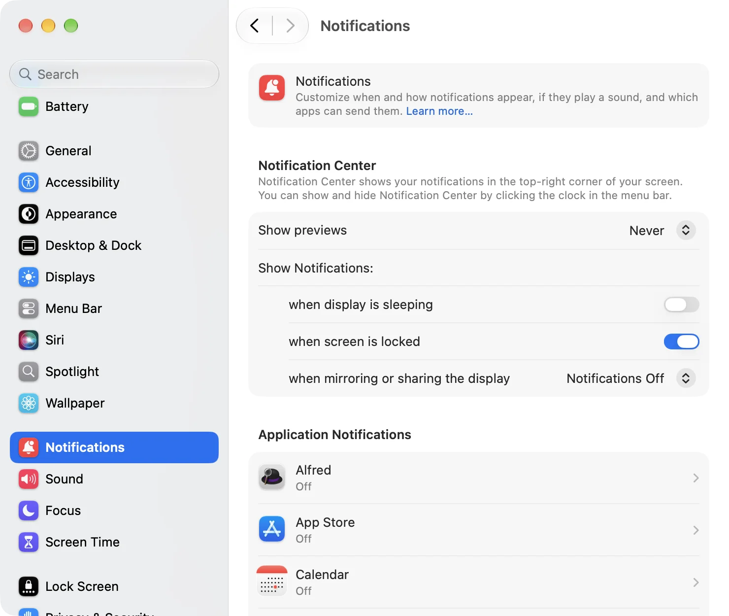 The top of the Notifications page in System Settings. Show previews is set to Never. Under Show Notifications: when display is sleeping (switch, off), when screen is locked (switch, on), and when mirroring or sharing the display (pop-up menu, Notifications Off). Below, Application Notifications lists Alfred, App Store, and Calendar, each marked Off
